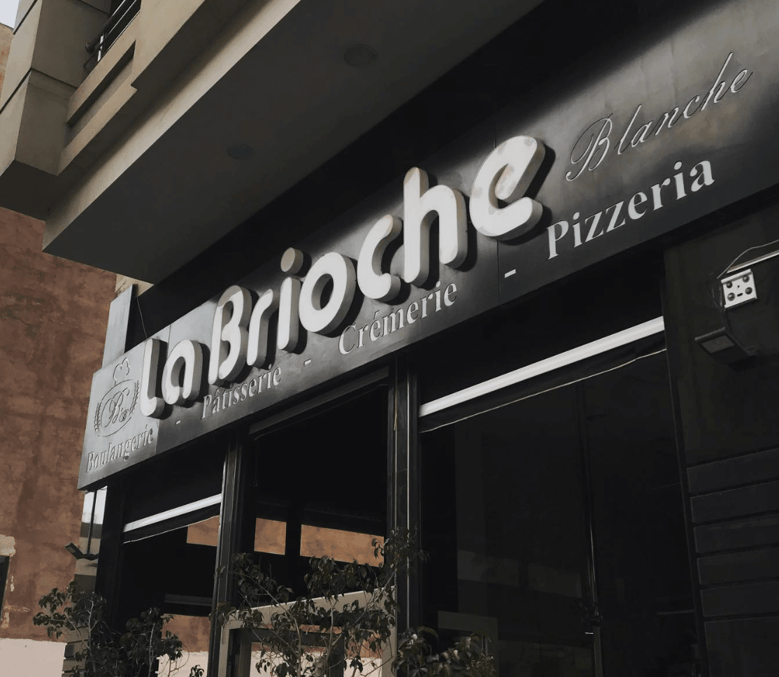 La Brioche Blanche bakery interior with fresh pastries, elegant decor, and warm ambiance